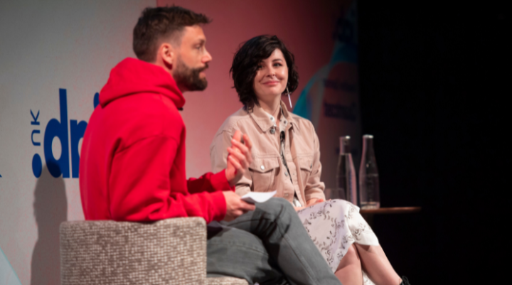 Two people on stage at an IAB event